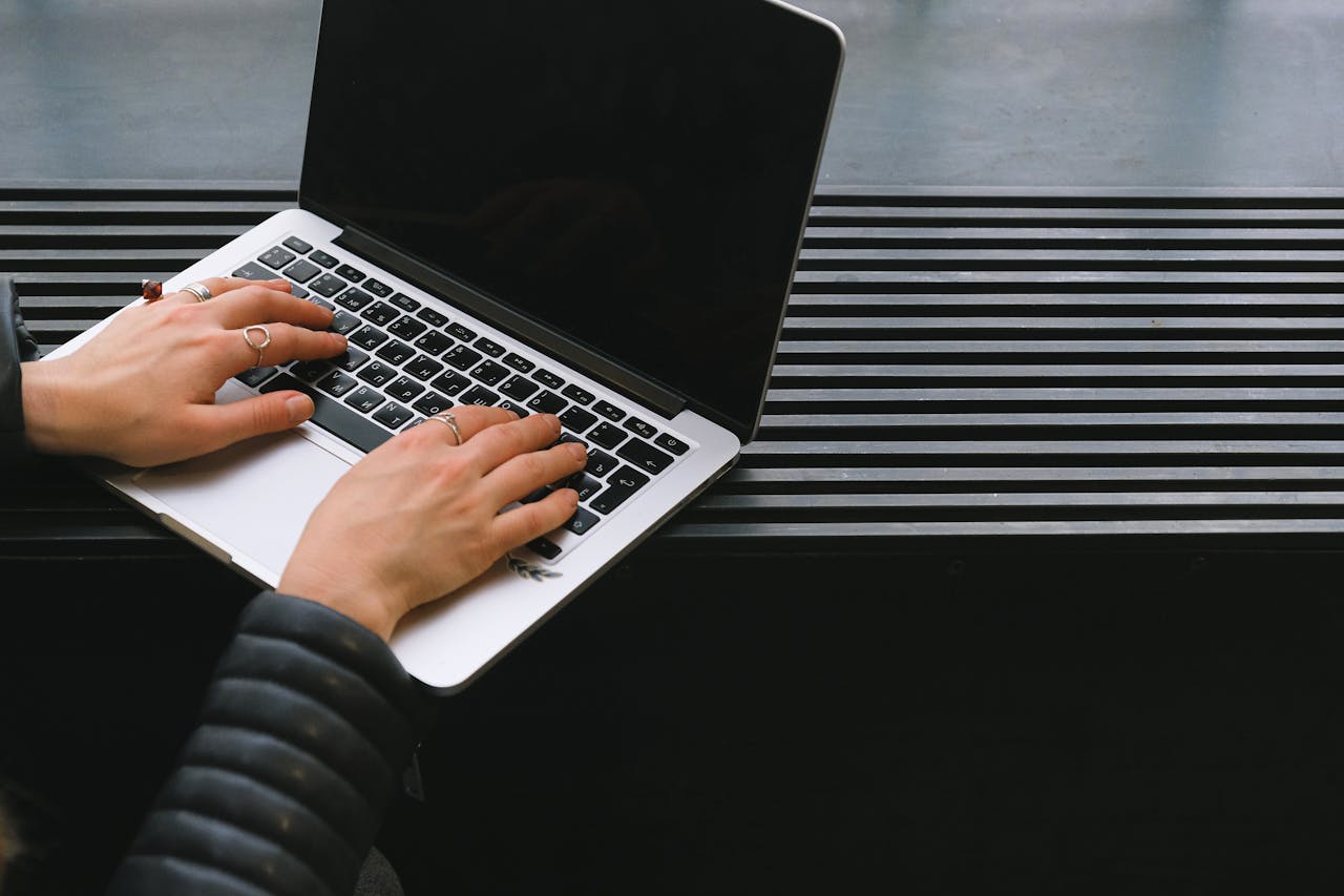 Crafting Captivating Headlines: Your awesome post title goes here Close-up of hands typing on a sleek laptop, ideal for freelance work.